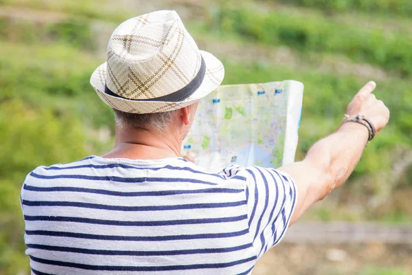 tourist with map pointing a direction