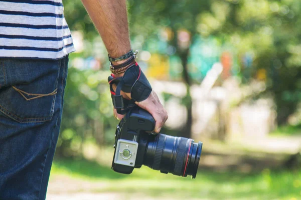 photographer holding digital photo camera