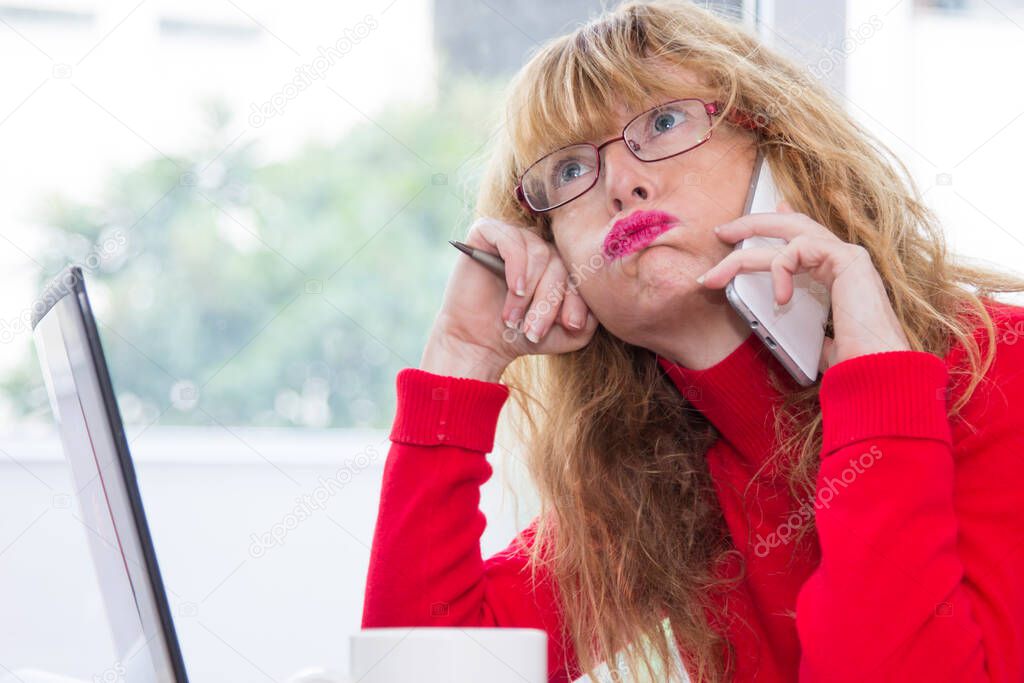 stressed and overwhelmed business woman talking on the mobile phone