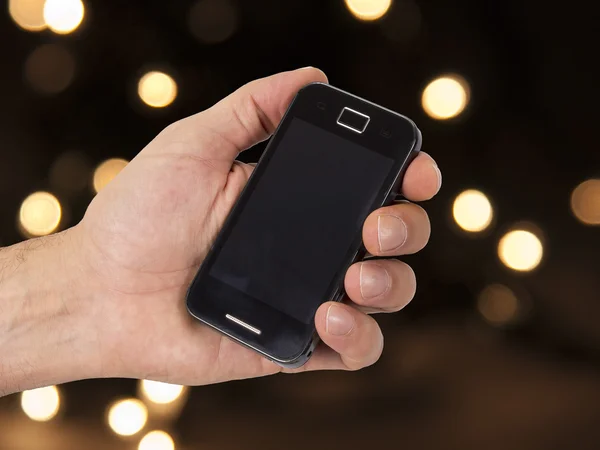 Cellulare e mano con sfondo di Natale — Foto Stock