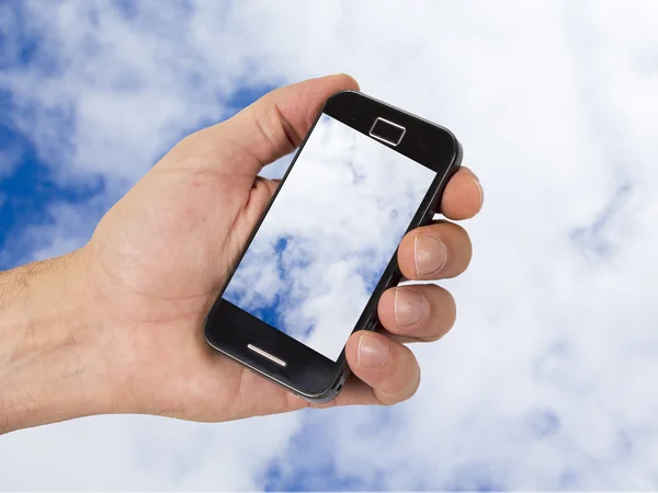 Mobiele en hand met hemelachtergrond met internet termen — Stockfoto