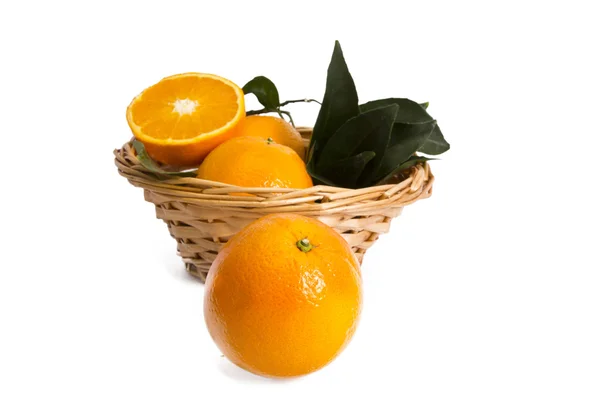 Basket of oranges on wooden board — Stock Photo, Image