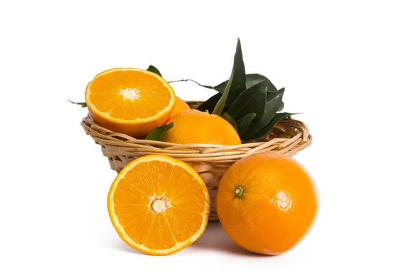 Basket of oranges on wooden board — Stock Photo, Image