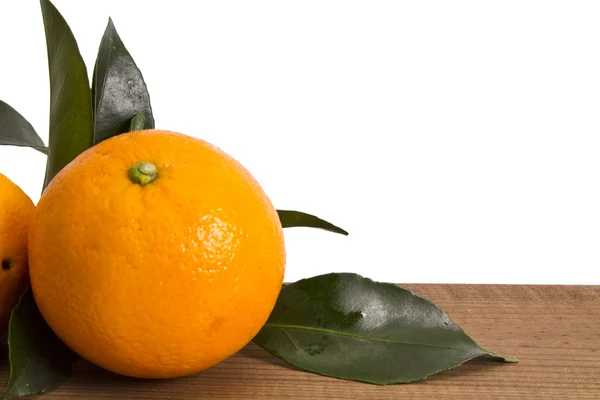 Basket of oranges on wooden board — Stock Photo, Image