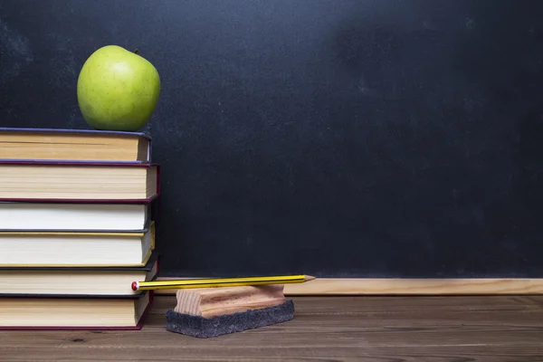 Blackboard and books — Stock Photo, Image