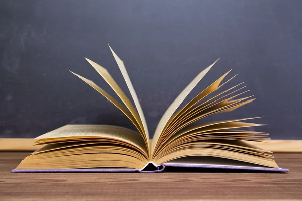 Blackboard and books — Stock Photo, Image