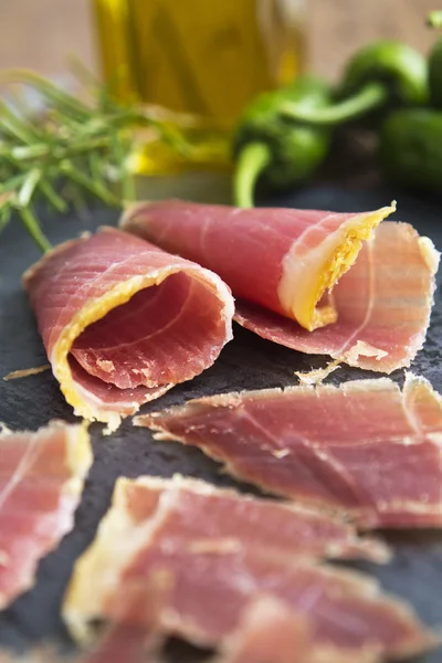 Serrano ham with  green rosemary and oil — Stock Photo, Image