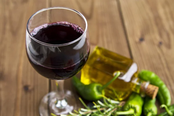 Cup of wine with oil and green peppers — Stock Photo, Image