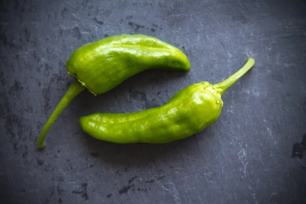 Green peppers on  black board — Stock Photo, Image