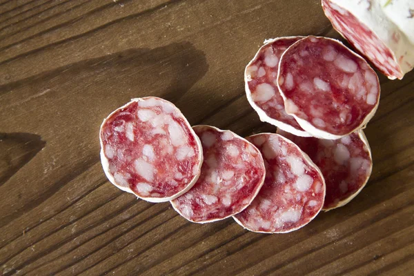 Salami and bread on wooden — Stock Photo, Image