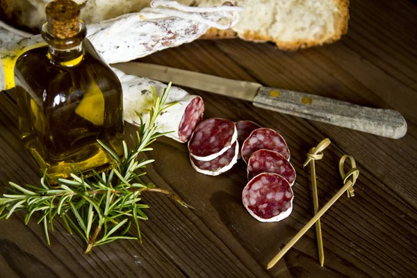 Salami and bread on wooden — Stock Photo, Image