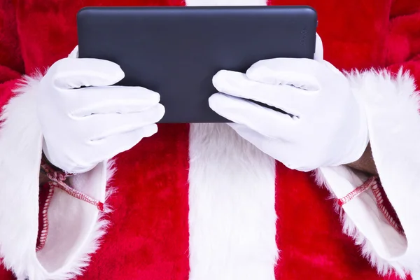 Papai Noel deitado com o tablet preto — Fotografia de Stock