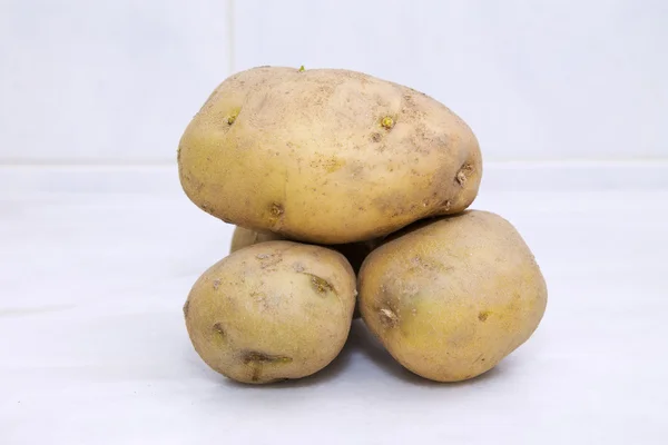 Potatoes on tiles — Stock Photo, Image