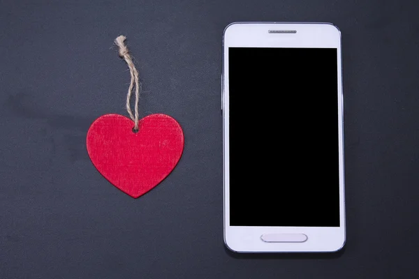 Mobile with heart and background — Stock Photo, Image