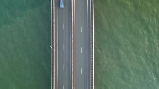 Aerial forward Vladivostok costal cityscaspe low-water bridge across blue sea. — Stock Video