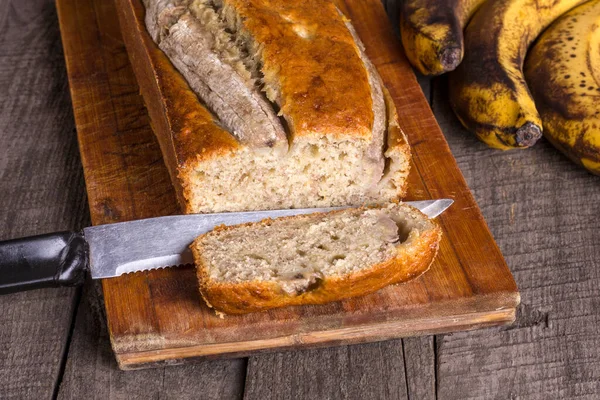 Traditional american dish sliced banana bread without gluten and dairy products on wooden background.