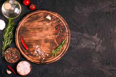 Siyah bir masanın üzerinde yuvarlak tahta kesme tahtası. Boş mutfak, modaya uygun ahşap tepsi manzarası