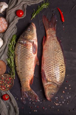 Tahta bir tahtanın üzerinde pişmeye hazır iki sazan balığı yakaladım. Üst görünüm, alanı kopyala.