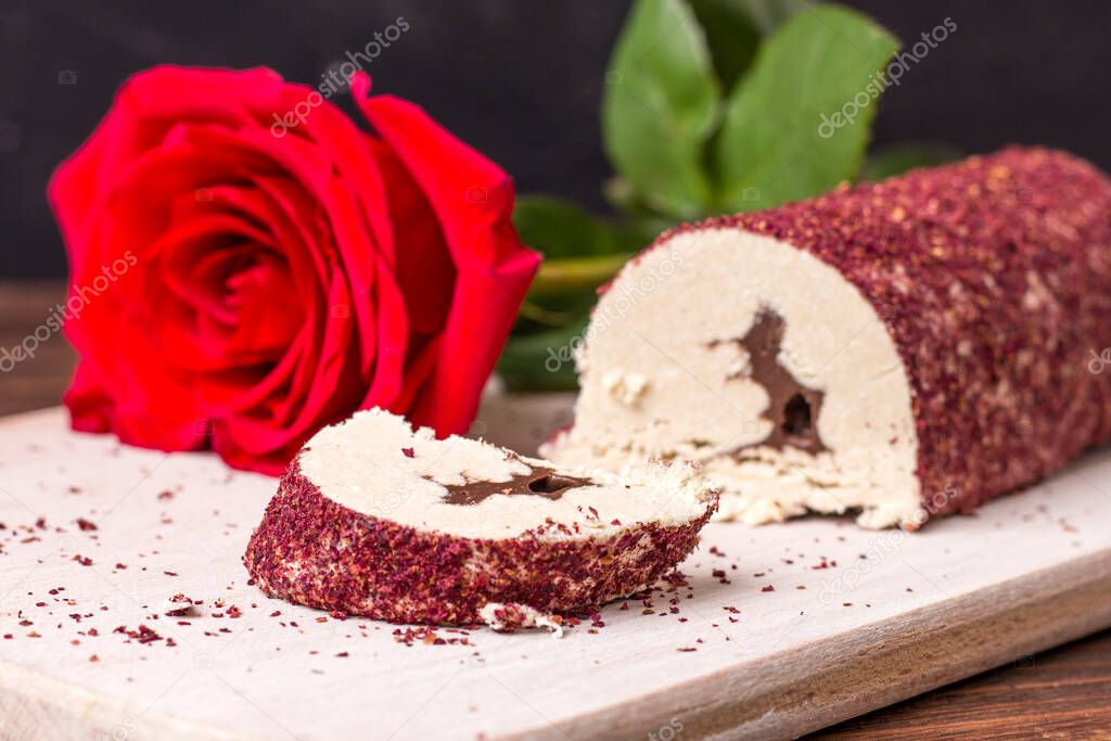 Eastern sweet halva with chocolate and rose powder on wooden background