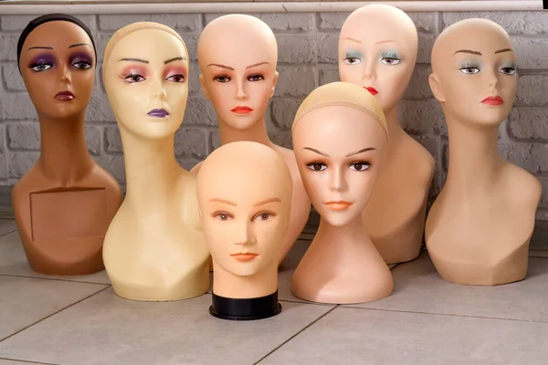 Female mannequin heads with makeup without hair. Delivery of goods for purchases during the coronavirus. Shop of commercial equipment