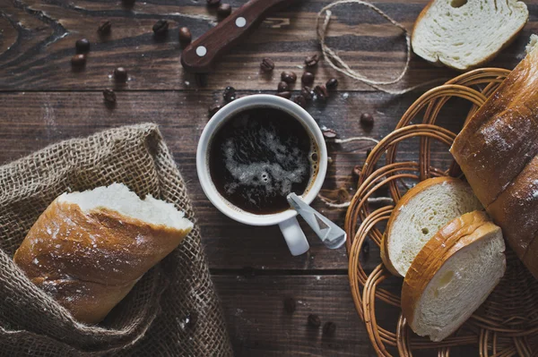 Op de tafel is een mok koffie en het brood 5103 gesneden. — Stockfoto