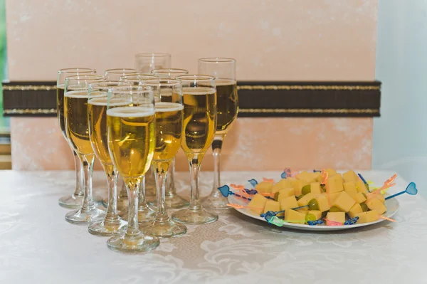 Pyramiderna i champagneglas och en tallrik med ost 5185. — Stockfoto