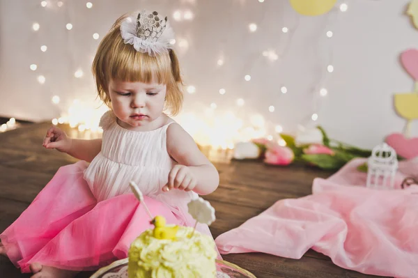 stock image A little girl sitting in front of a sweet cake 5376.