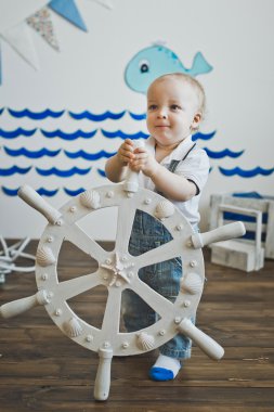 Küçük çocuk elinde 5550 dümen tutar..