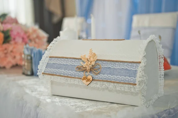 On the table is a wedding chest for money and congratulations for the bride and groom.