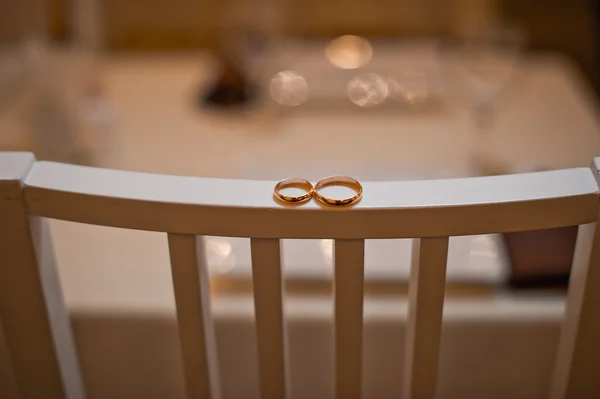 Wedding rings on a chair back 709. — Stock Photo, Image