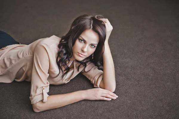 The girl in a shirt lies on a floor 1998. Stock Picture