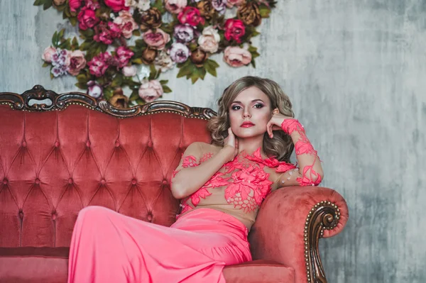 The girl in a pink dress on a sofa 2581. — Stock Photo, Image
