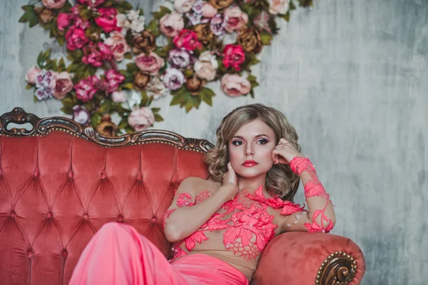 The girl in a transparent pink dress on a sofa 2582. — Stock Photo, Image