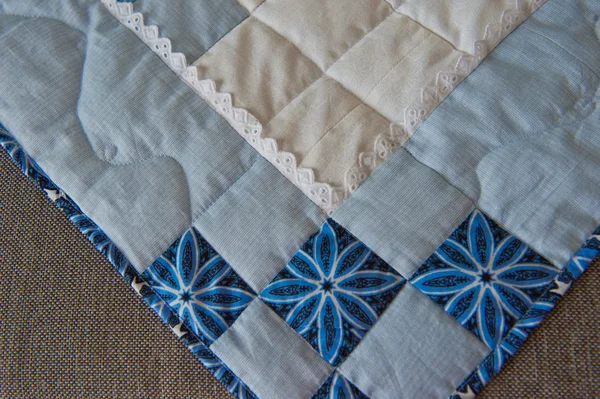 Embroidered by dark blue and white patterns a scrappy blanket 29 — Stockfoto