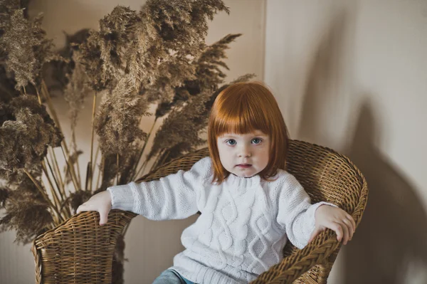 Child with red hair in a white sweater 4409. — Stock Photo, Image