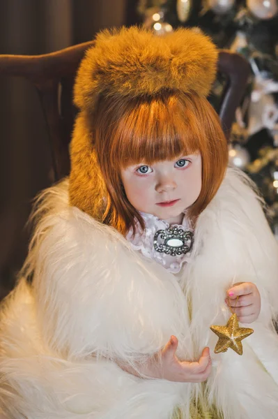 Portrait of a child in a fur coat around the Christmas tree 4547 — Stock Photo, Image