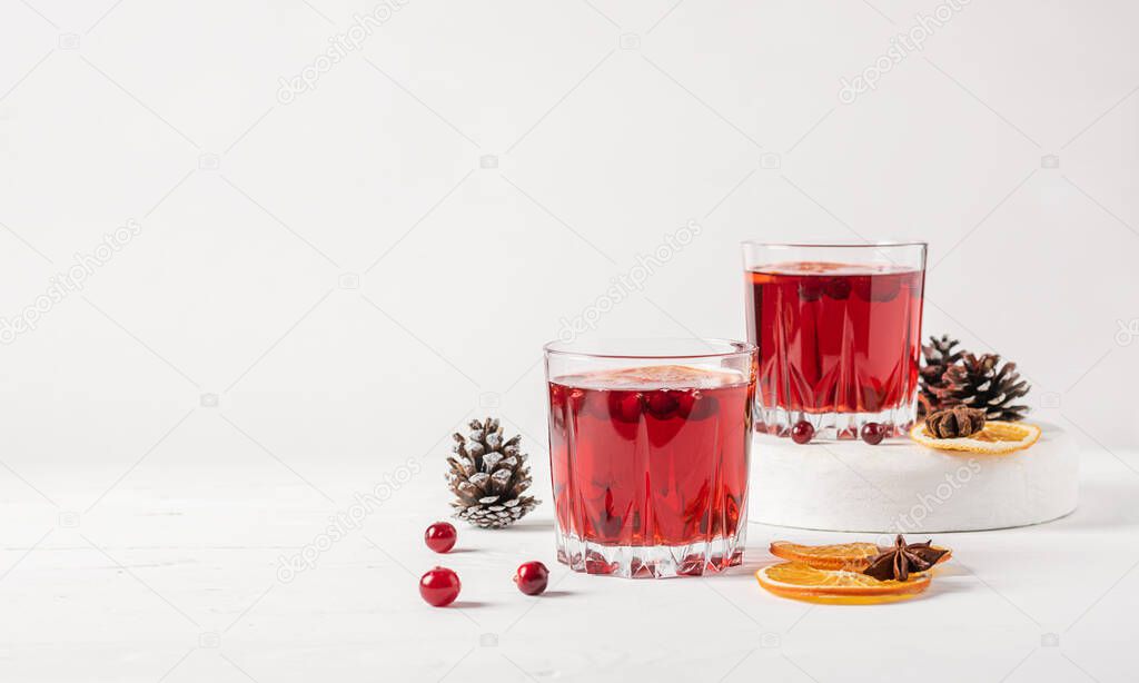 Winter drink cocktail mulled wine orange cranberries glasses white background.