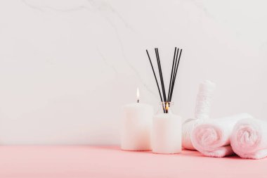 Incense sticks candles towelmassage herbal bags white marble background. Massage, oriental therapy, alternative medicine