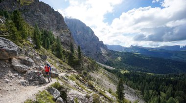 Yürüyüş için güzel bir gün: Genç sporcu kadın güney Tyrol 'da Dolomite' larla güzel bir patikada yürüyüş yapıyor. Gardena Vadisi, İtalya.