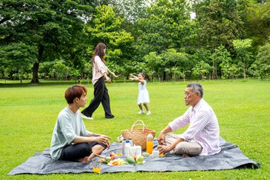 Babam ve büyükbabam halk parkındaki çimenlerde oturur ve anne ve torun arasında gün ışığıyla oynamaktan zevk alırlar..