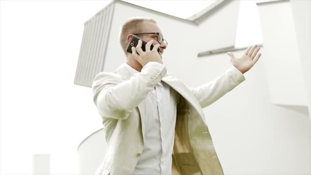Счастливый кавказский бизнесмен наслаждается позитивным деловым разговором по телефону — стоковое видео