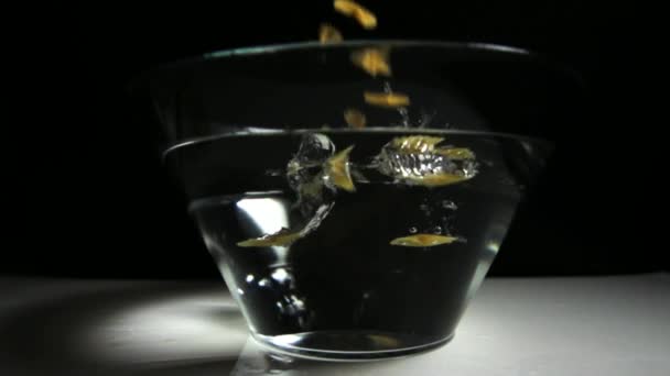 Pasta dropping in bowl with water — Stock Video