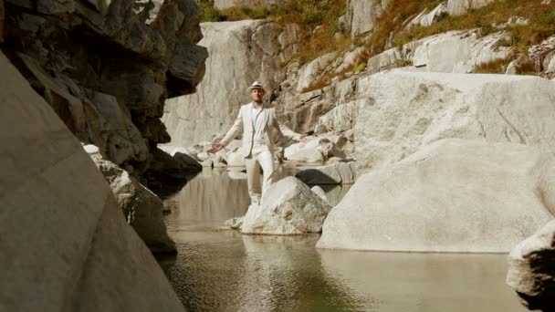 Man is standing in nature, raising hands — Stock Video