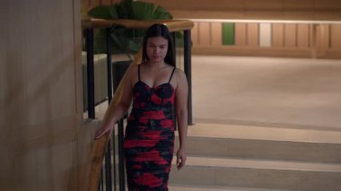 elegant woman descending patterned stairs, graceful lady walks down staircase in patterned dress