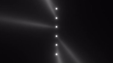 Yumuşak kirişler ve zarif gri pullu koyu arkaplan üzerinde dikey beyaz ışık noktaları