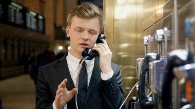 telefon kulübesi kullanan adam