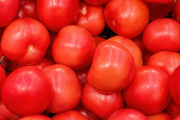 Fresh pink tomatos on a market counter