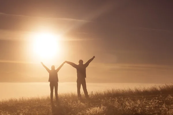 Silhouette active couple in love with Trekking pole in the morning fog — Stock Photo, Image