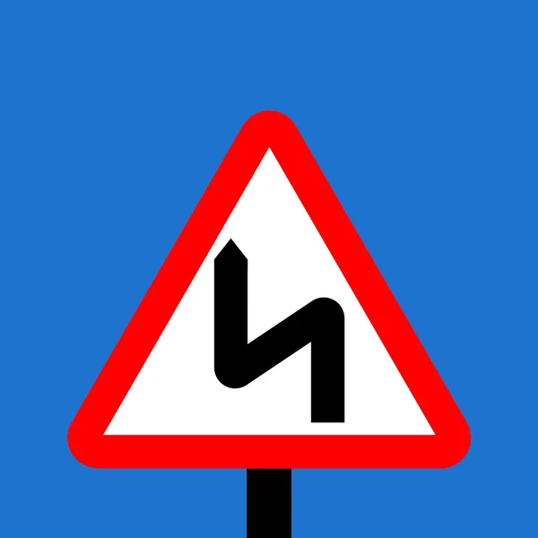 Warning triangle Double bend first to left sign — Stock Photo, Image