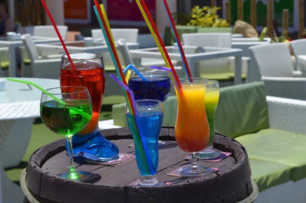 Cocktails outside a bar on top of a beer barrel